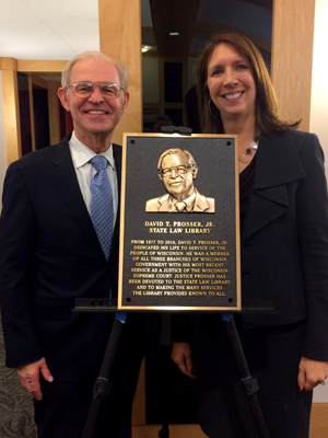 Julie Tessmer and David Prosser standing in law library with plaque