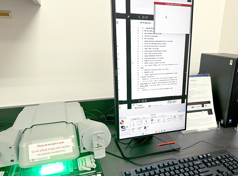 Microfiche reader and software on screen with a microfiche page on display