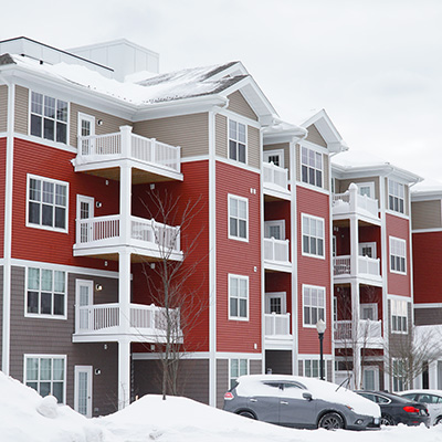 apartment building in winter with snow cover
