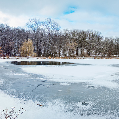 icy lake with thawing open water